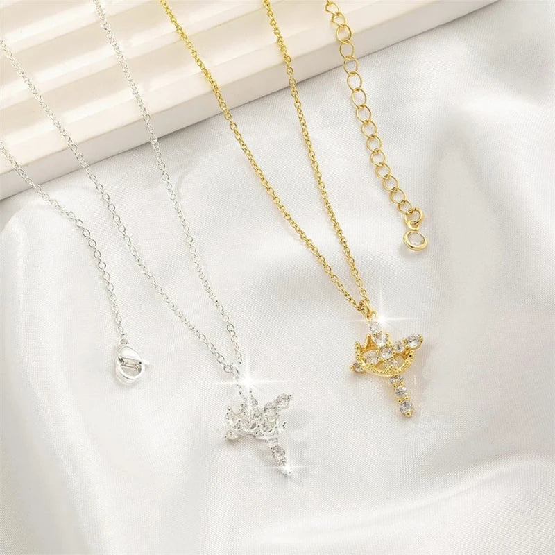 Silver and gold crown cross necklaces side by side